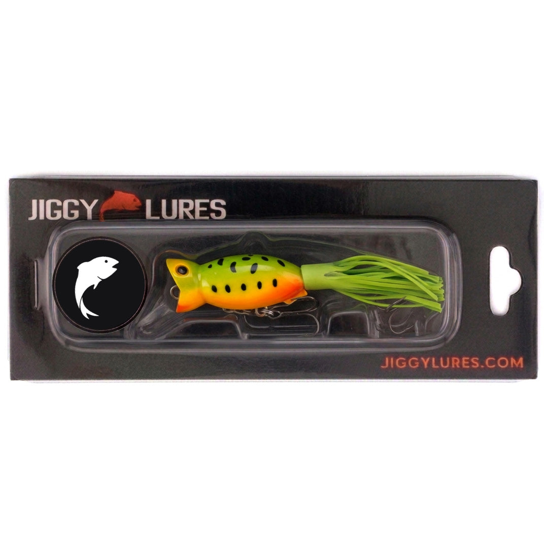 Fishing lure with green body and orange belly on a white background