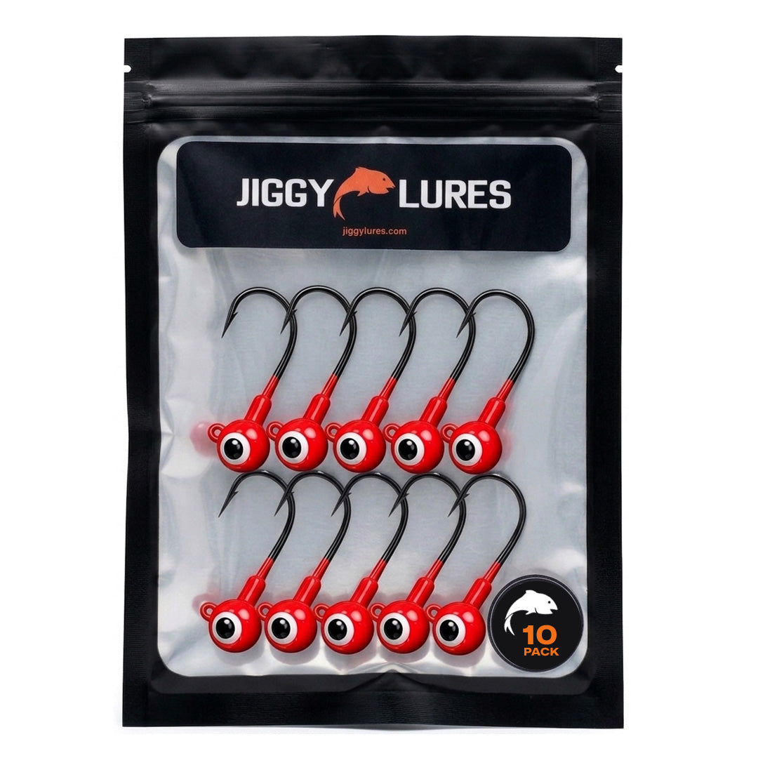 Red fishing lure with a black eye and hook on a white background